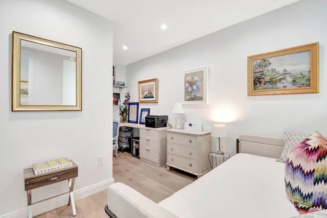 a bedroom with 2 bed and a furniture