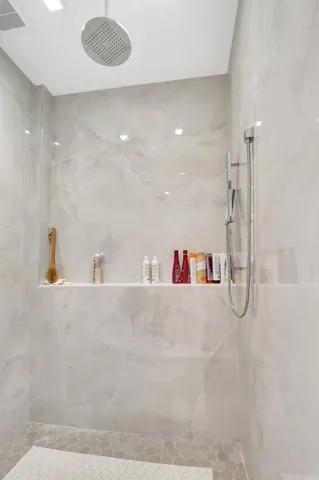 a bathroom with a tub and a shower