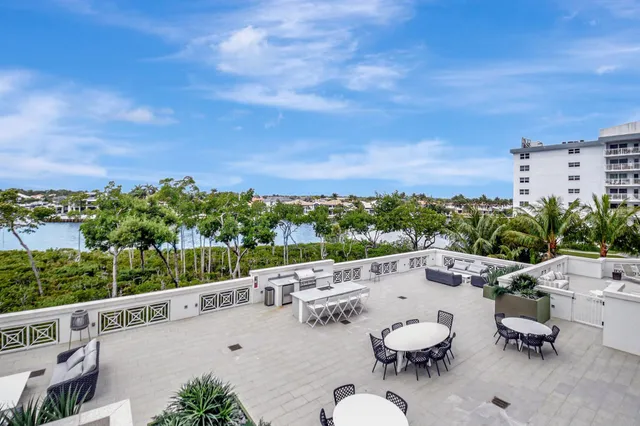 a view of a terrace with furniture and a garden