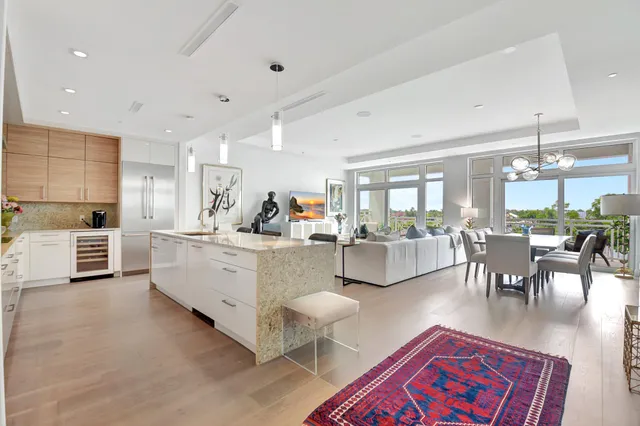 a living room with furniture a dining table and kitchen view