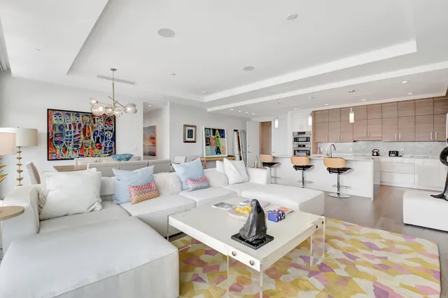 a living room with furniture and kitchen view