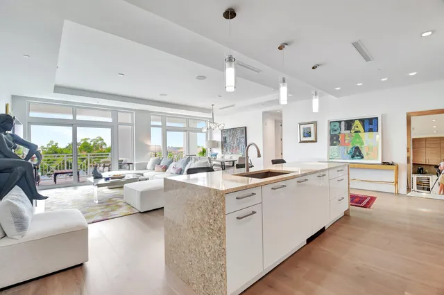 a large white kitchen with a large window