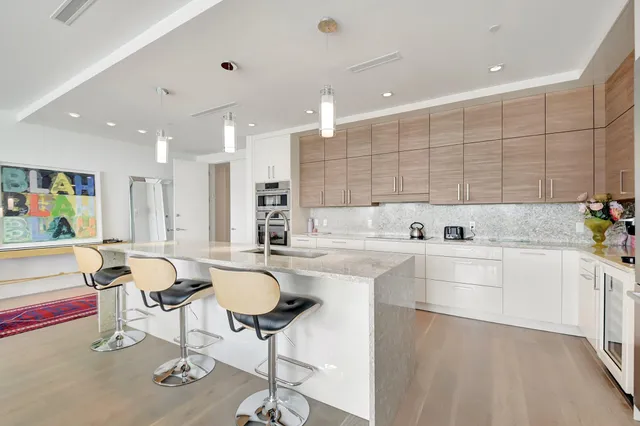 a large kitchen with lots of counter space and furniture