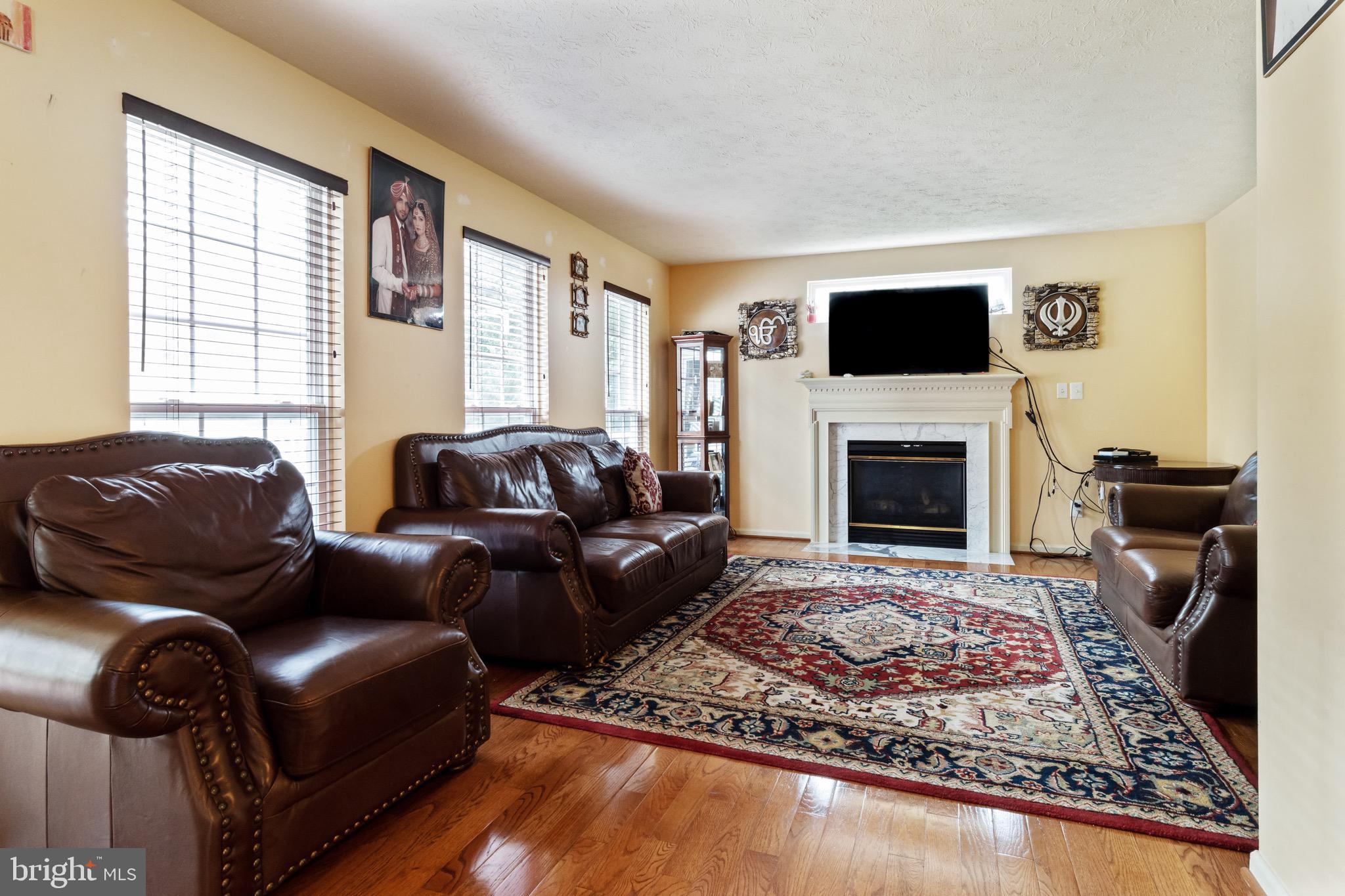 Living Room w/ Hardwood and Fireplace