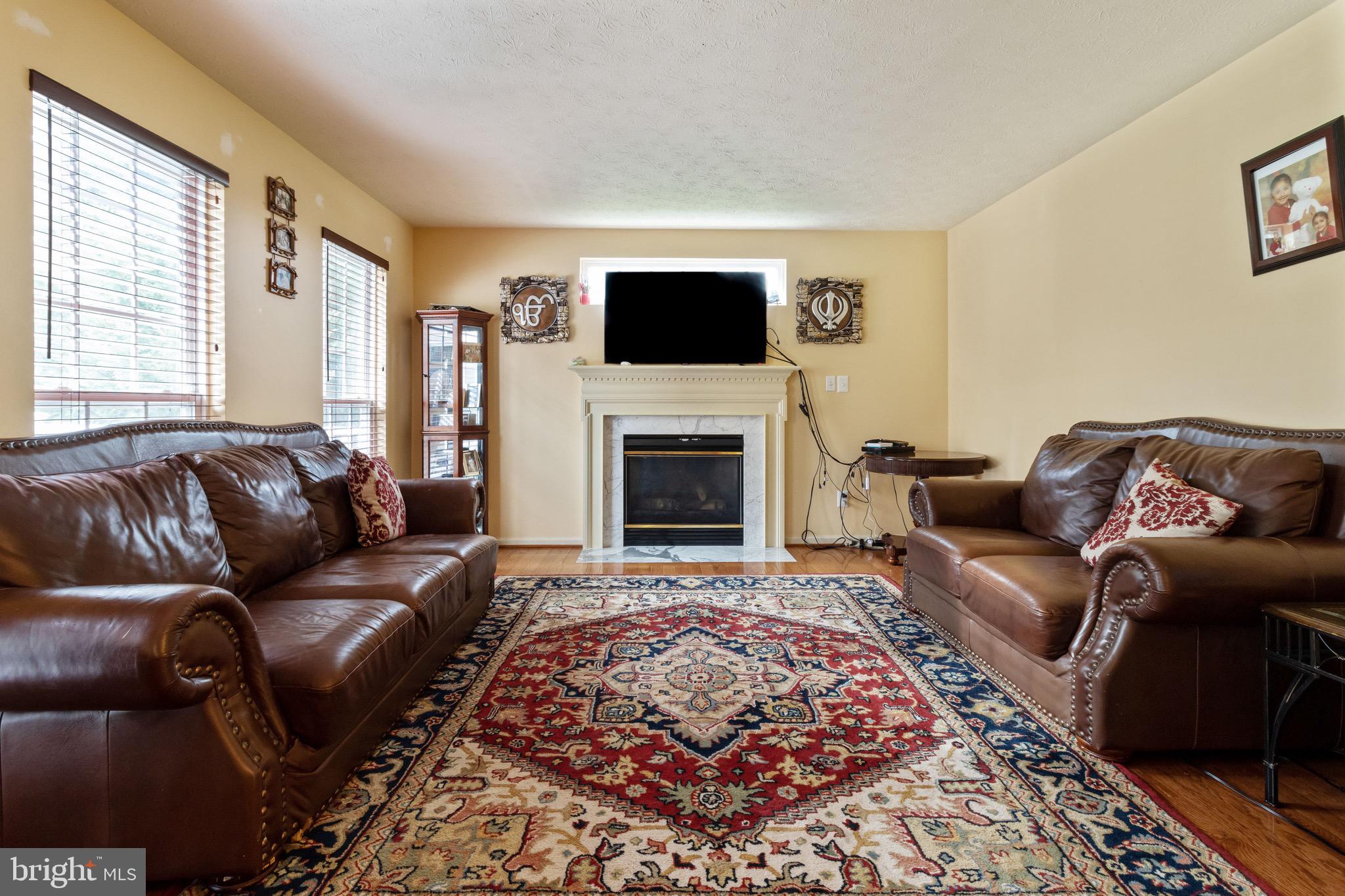 7751 Rotherham Drive Hanover, MD 21076 - Photo 10 of 42 Living Room w/ Hardwood and Fireplace