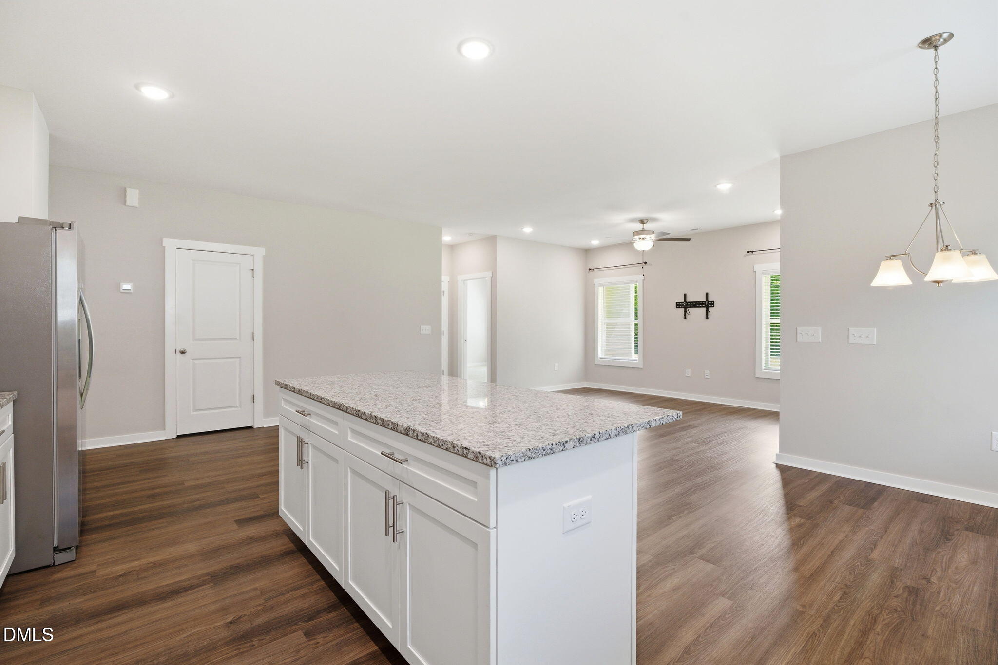 161 Tupelo Dr Spring Spring Hope, NC 27882 - Photo 11 of 28 a open kitchen with kitchen island a sink dishwasher a refrigerator and a fireplace with wooden floor