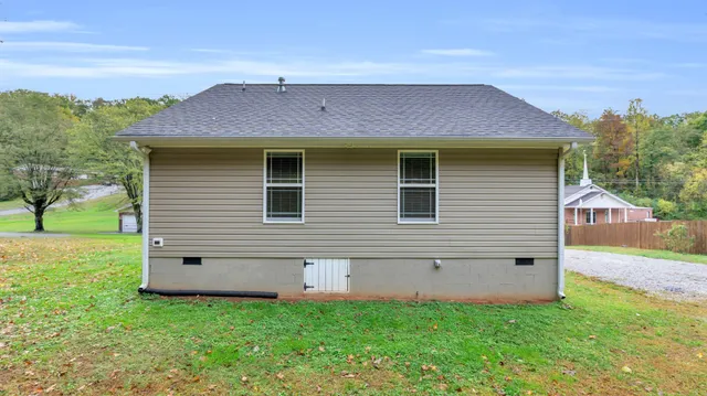 a view of a backyard with large trees