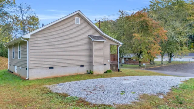 a view of backyard of house with green space