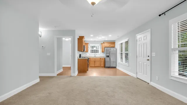 a view of a kitchen and refrigerator