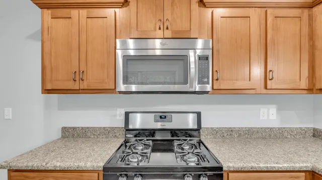 a stove top oven sitting inside of a kitchen