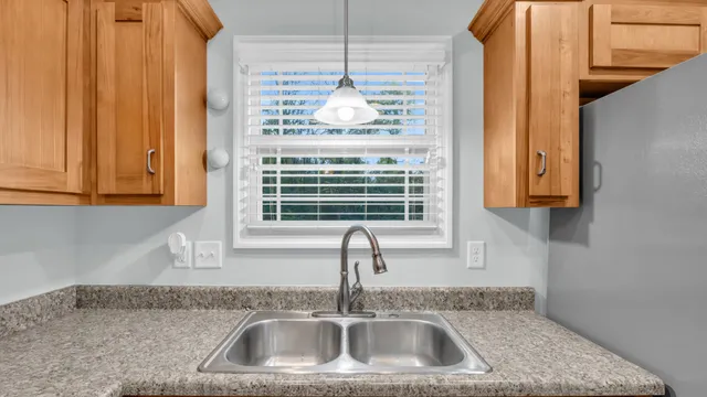 a kitchen with a sink and a window