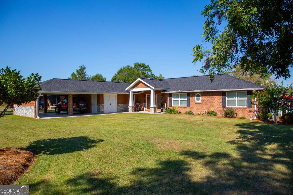 a front view of a house with a garden
