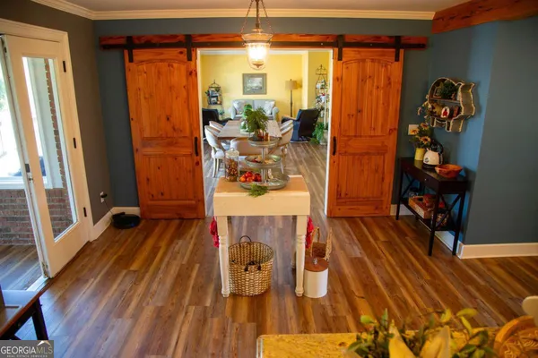 a view of a room with wooden floor and furniture