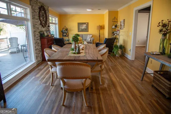 a view of a dining room with furniture and wooden floor