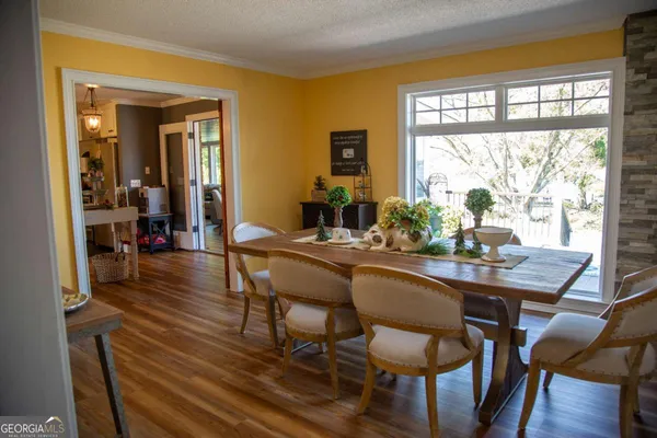 a dining room with furniture and wooden floor