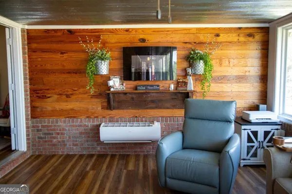 a living room with furniture and a floor to ceiling window