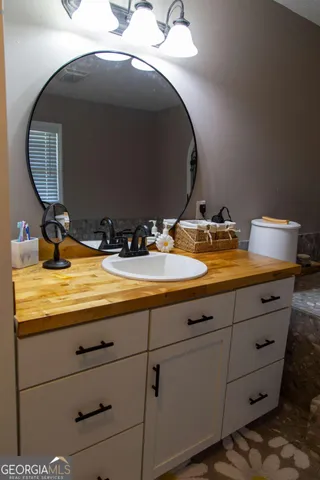 a bathroom with a sink and a mirror