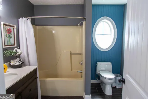 a bathroom with a toilet a sink and a mirror