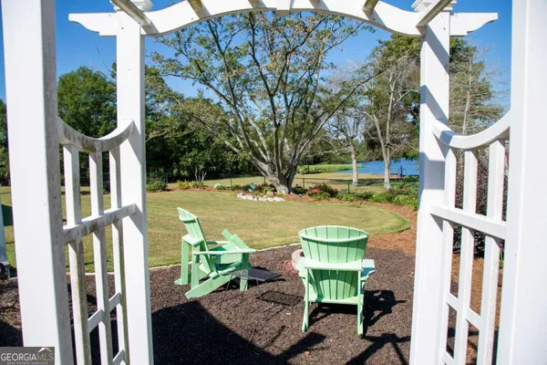 a view of a chair and table in backyard