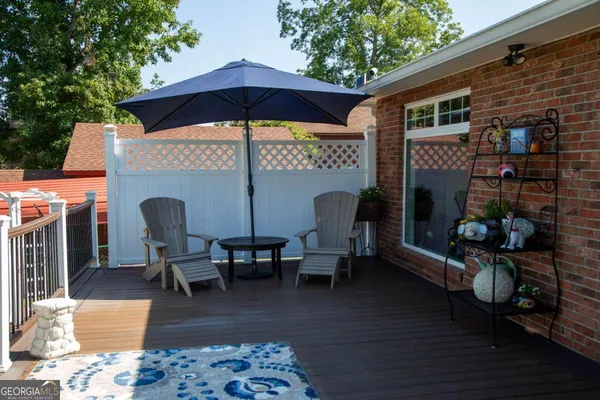 a view of a roof deck with wooden floor and outdoor seating