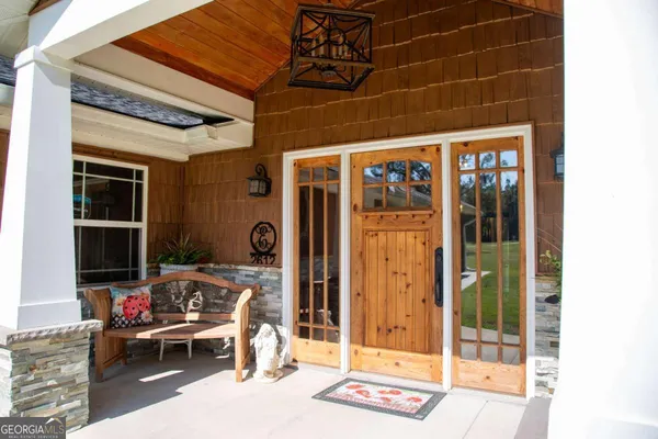 a view of a door and chair in front of a house