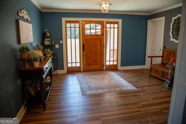 a view of an entryway with wooden floor