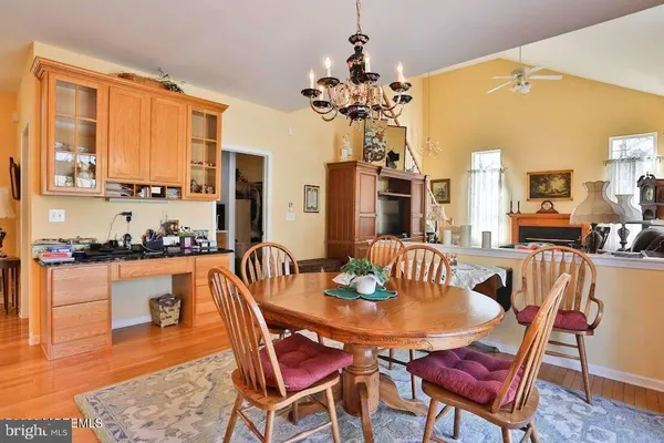 a dining room with furniture and wooden floor