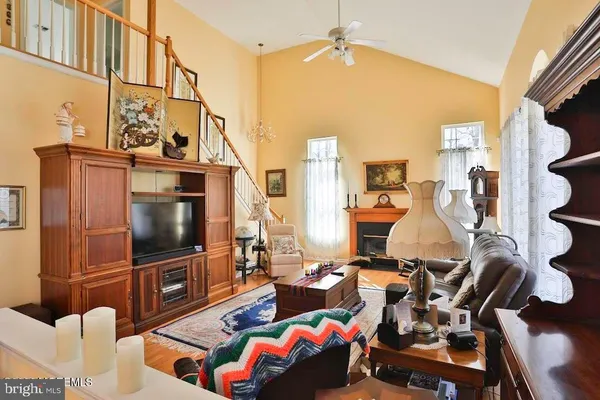 a living room with furniture a flat screen tv and gym equipment
