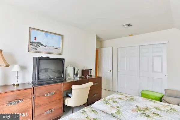 a bedroom with a bed and a fireplace