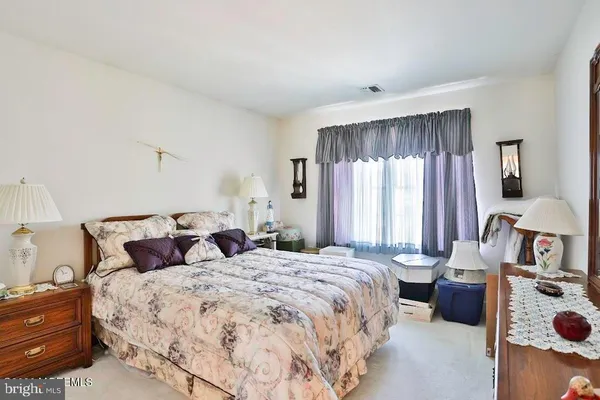 a bedroom with double bed and a window