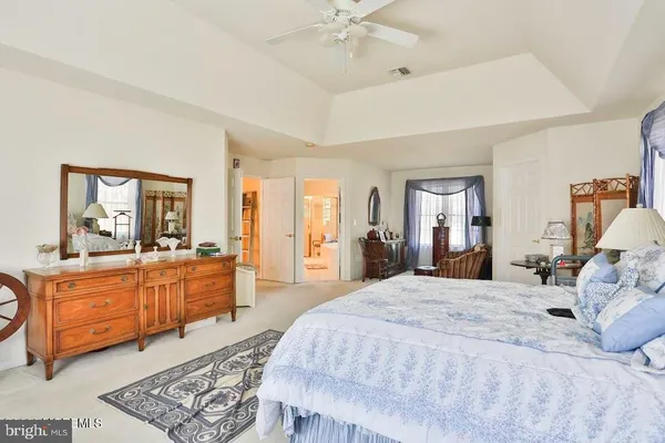 a large bedroom with a large bed and wooden floors