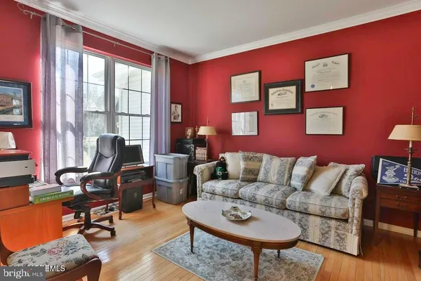 a living room with furniture a rug and a window