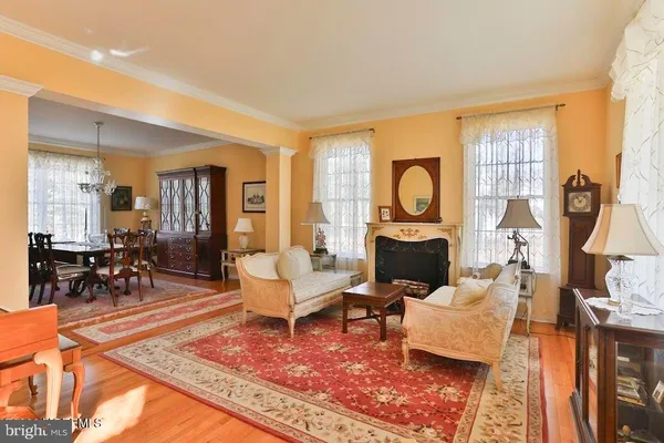a living room with furniture a rug and a floor to ceiling window