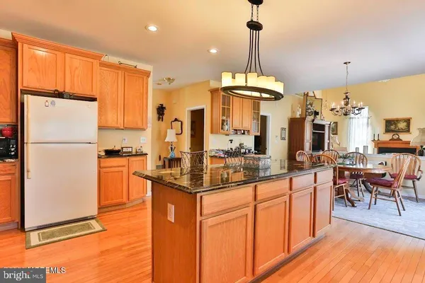 a kitchen with stainless steel appliances granite countertop a refrigerator a sink and a stove