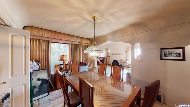 a kitchen with stainless steel appliances a sink cabinets and a window
