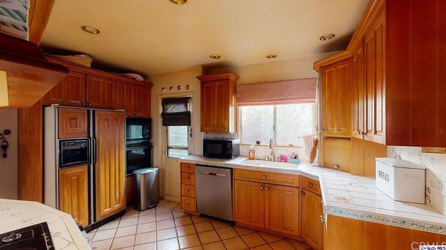 a kitchen with stainless steel appliances granite countertop a sink and cabinets