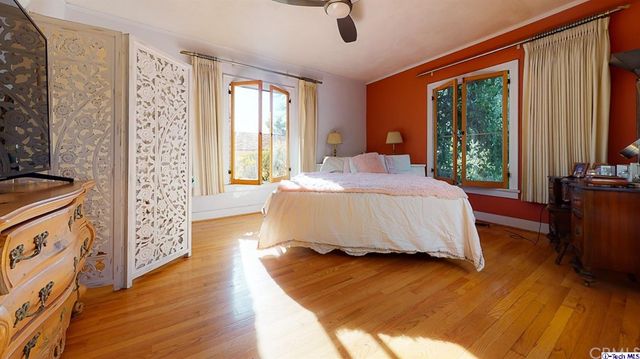 a bedroom with furniture and flat screen tv
