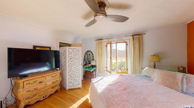 a bedroom with a large bed and a large window