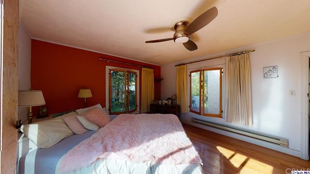 a bedroom with a bed and a television