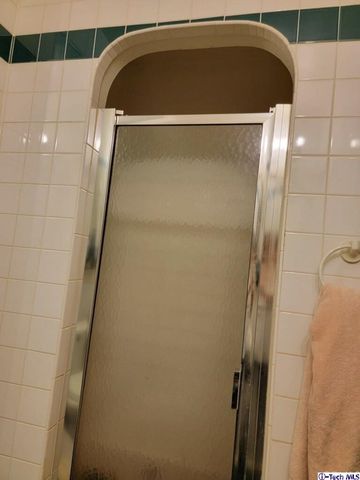 a bathroom with a mirror and a shower