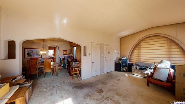 a view of a livingroom with furniture and bedroom