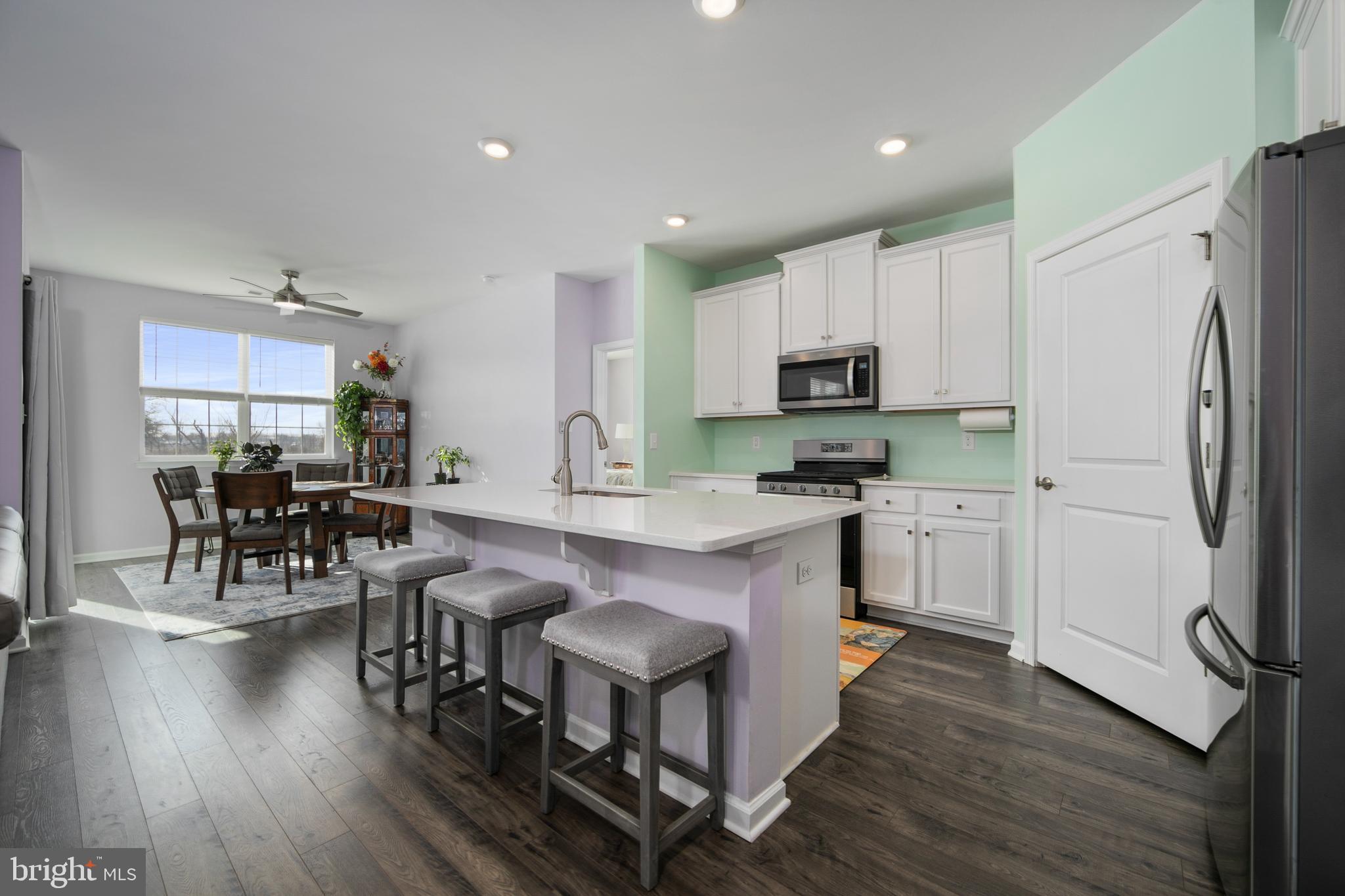 33 Walton Way Delanco, NJ 08075 - Photo 12 of 46 a kitchen with granite countertop stainless steel appliances a refrigerator a stove a sink a dining table and chairs with wooden floor