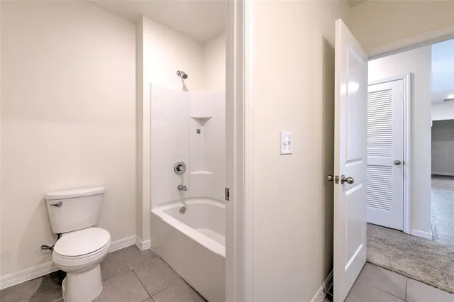 a bathroom with a bathtub and toilet