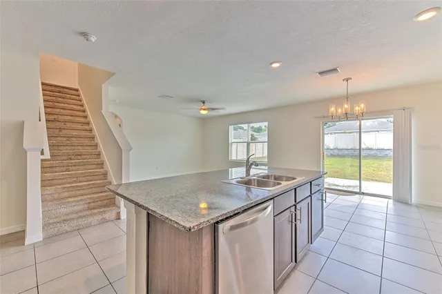 a kitchen with granite countertop a sink and a stove