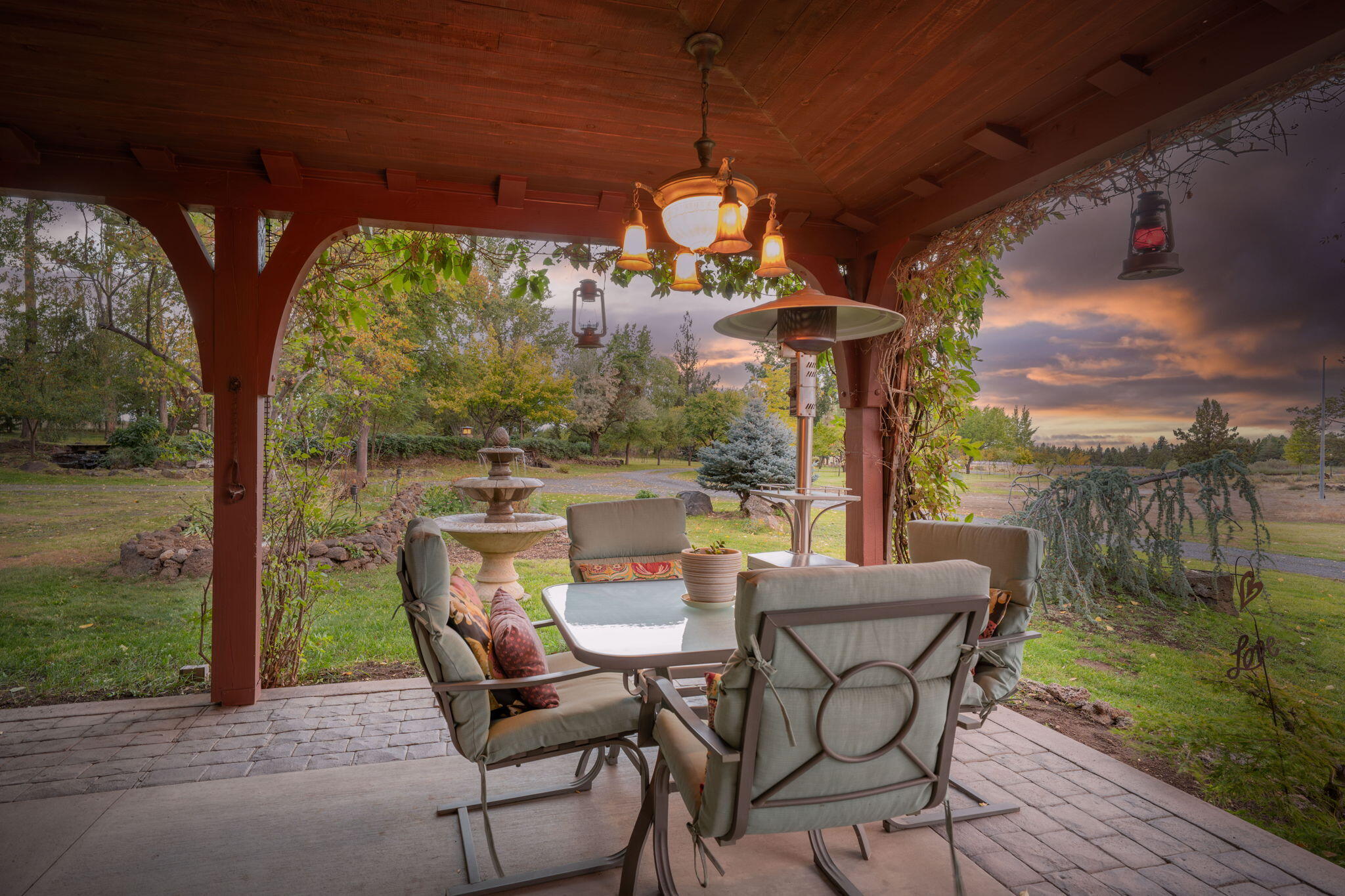 21925 Bear Creek Road Bend, OR 97702 - Photo 90 of 104 a view of a patio with a table chairs and a floor to ceiling window