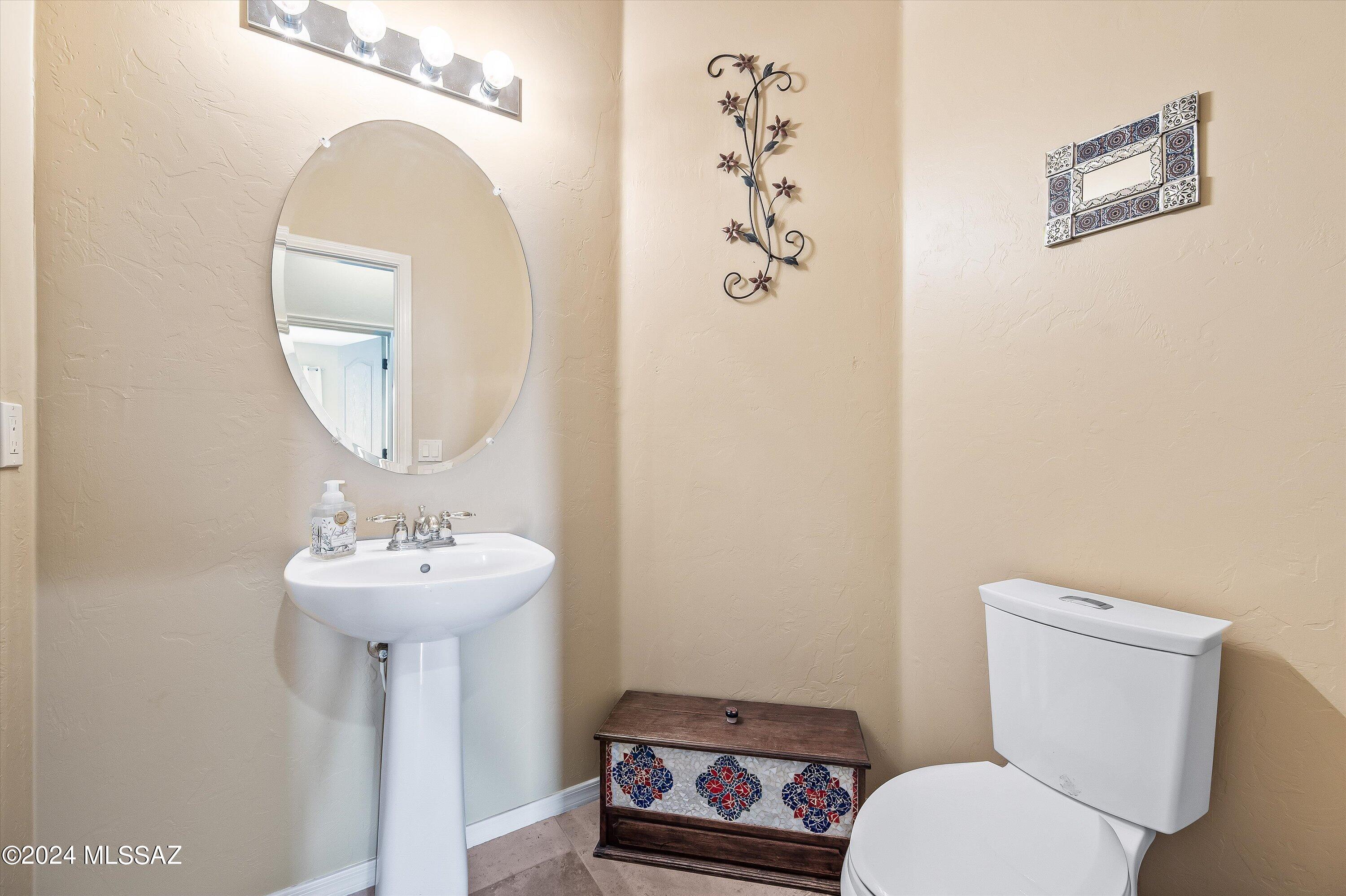 8579 North Shadow Wash Way Tucson, AZ 85743 - Photo 20 of 34 a bathroom with a toilet sink and mirror