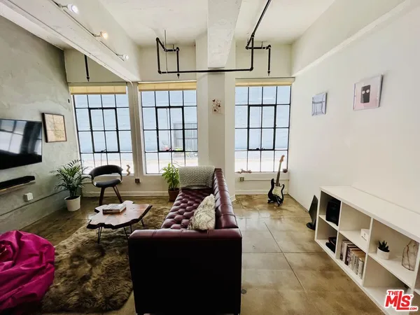 a living room with furniture fireplace and rug floor