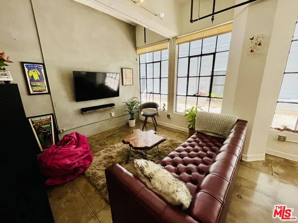 a view of a livingroom with furniture window and wooden floor