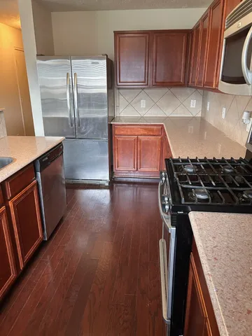a kitchen with wooden floors and a stove