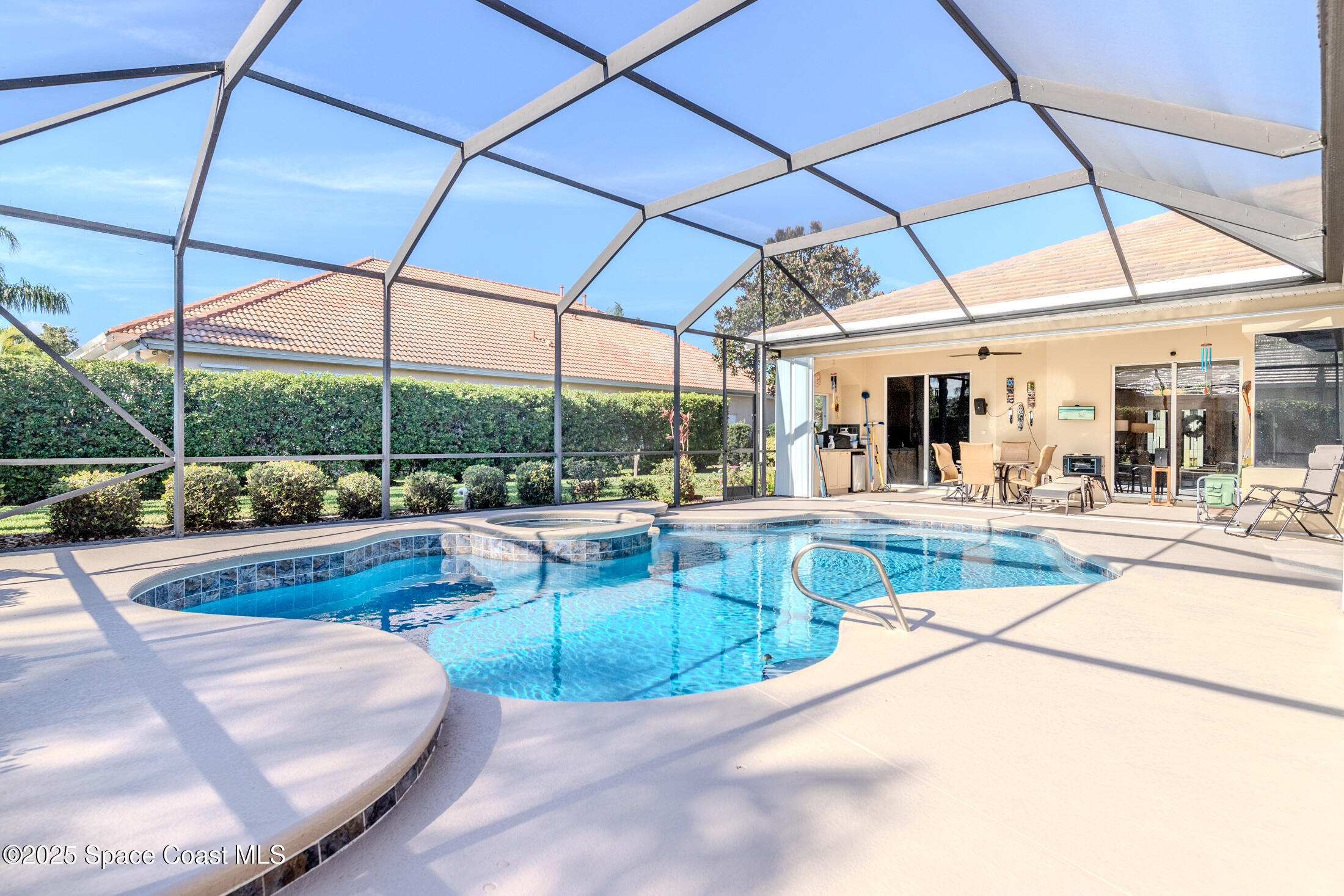 8201 Compton Way Melbourne, FL 32940 - Photo 42 of 52 a view of a patio with a table and chairs under an umbrella